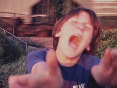 Sam Harkness, age 11, screams as a freight train passes by Sam at the Beach, Color Super-8mm, 1998&nbsp;
