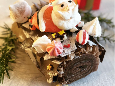 <a href="https://everout.com/stranger-seattle/locations/fuji-bakery/l16700/">Fuji Bakery</a>'s b&ucirc;che de No&euml;l comes adorned with an adorable hand-piped meringue Santa.
