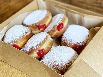 Don't wear a dark shirt to eat these powdery jelly doughnuts from <a href="https://everout.com/seattle/locations/raised-doughnuts/l14857/">Raised Doughnuts &amp; Cakes</a>&mdash;ask us how we know.